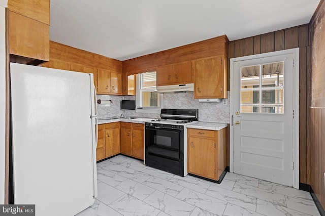 3142 Yorkway, Baltimore, MD 21222 - kitchen featuring freestanding refrigerator, gas range oven, under cabinet range hood, light marble finish flooring, and light countertops