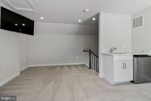 bar area with a sink, light carpet, fridge, recessed lighting, and baseboards