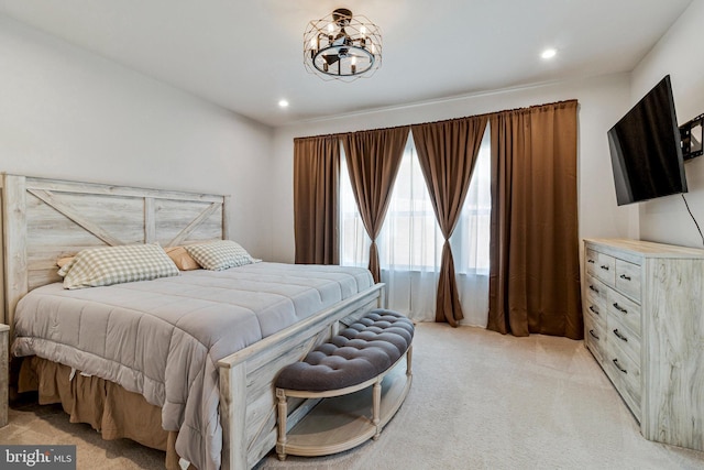 bedroom featuring light colored carpet, a chandelier, and recessed lighting