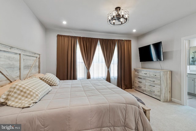 bedroom with light carpet, a chandelier, ensuite bath, recessed lighting, and baseboards