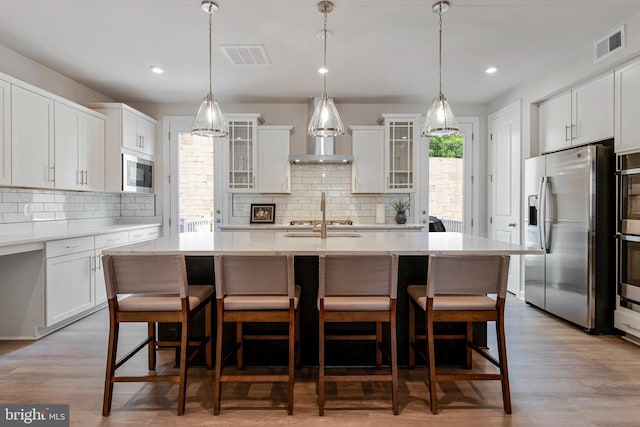 kitchen featuring stainless steel appliances, backsplash, glass insert cabinets, and recessed lighting