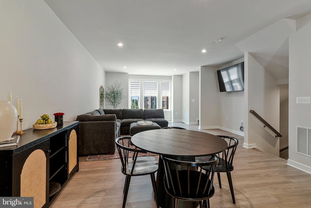 dining space featuring light wood-type flooring, recessed lighting, and baseboards