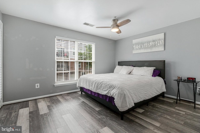 bedroom featuring wood finished floors, baseboards, and ceiling fan