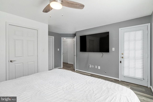 bedroom featuring wood finished floors, baseboards, and a ceiling fan