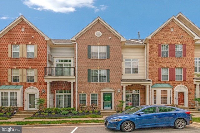 townhome / multi-family property featuring brick siding