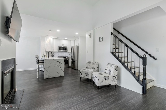 living room featuring dark wood-style floors, stairway, recessed lighting, and baseboards