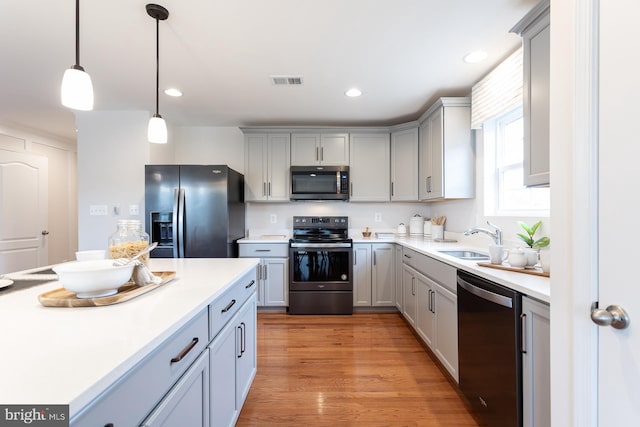 HOMESITE96 Pheasant Ridge Rd, Hanover, PA 17331 - kitchen with stainless steel appliances, gray cabinets, a sink, light countertops, and hanging light fixtures