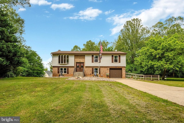 bi-level home with brick siding, driveway, and an attached garage