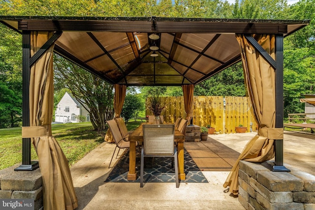 view of patio / terrace featuring fence, outdoor dining area, and a gazebo