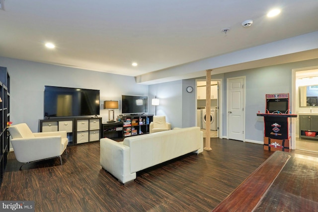 living room with wood finished floors, washer and dryer, and recessed lighting