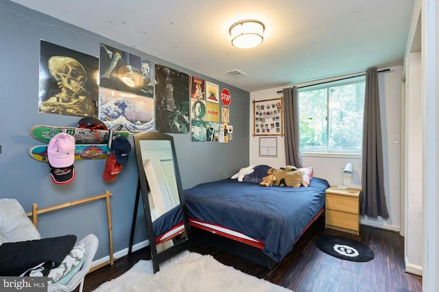 bedroom featuring baseboards and wood finished floors