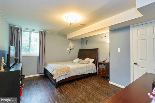 bedroom with wood finished floors and baseboards