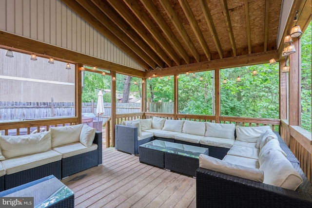 sunroom with an outdoor living space and vaulted ceiling