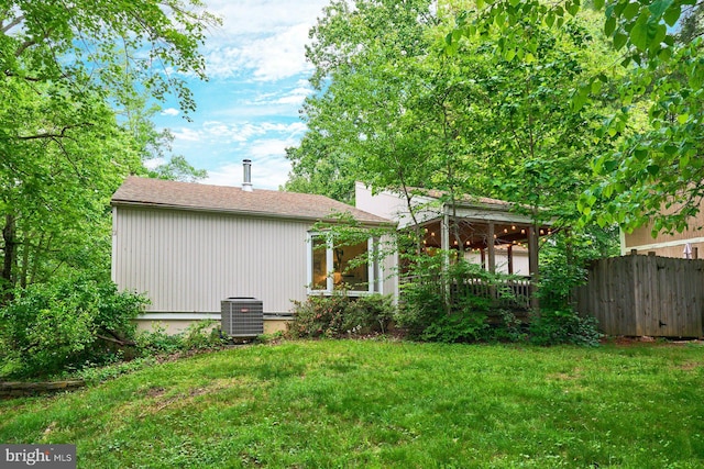 rear view of house with central AC unit