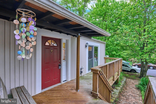 view of exterior entry with a wooden deck