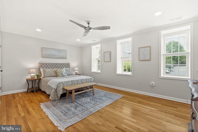 bedroom with crown molding, multiple windows, baseboards, light wood-type flooring, and recessed lighting