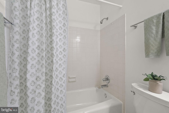 bathroom with toilet and shower / tub combo with curtain
