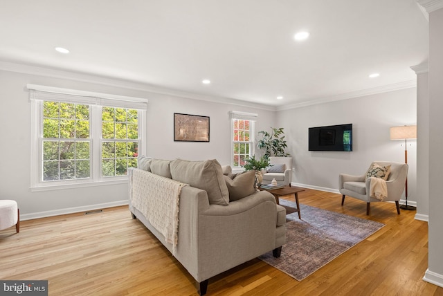 living area with recessed lighting, ornamental molding, light wood-style flooring, and baseboards