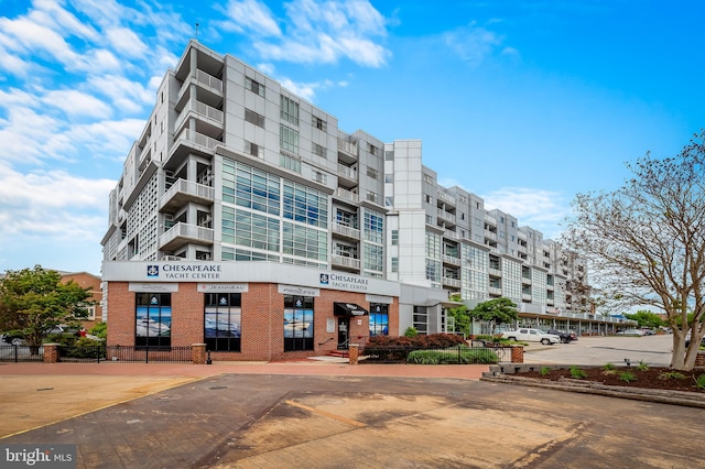 view of apartment building / complex with uncovered parking