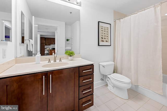 bathroom featuring tile patterned flooring, toilet, vanity, shower / bath combo with shower curtain, and baseboards
