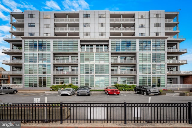 view of apartment building / complex with uncovered parking