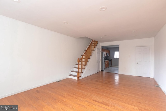 2106 S 12th St, Philadelphia, PA 19148 - below grade area featuring stairs, light wood-style flooring, recessed lighting, baseboards, and freestanding refrigerator