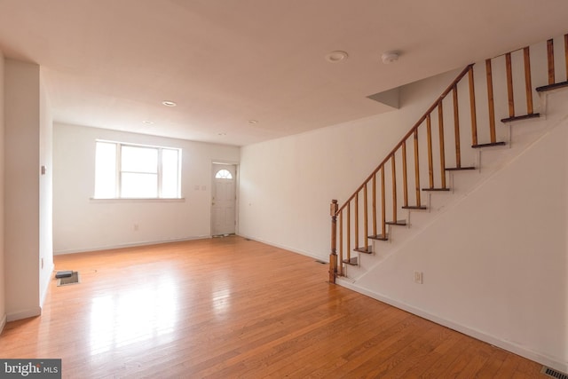 2106 S 12th St, Philadelphia, PA 19148 - unfurnished living room with wood finished floors, stairway, baseboards, and recessed lighting