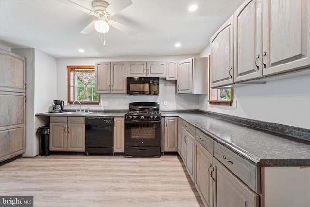 1127 Pawlings Rd, Norristown, PA 19403 - kitchen featuring black appliances, dark countertops, a sink, ceiling fan, and light wood-style flooring