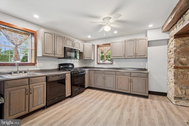 1127 Pawlings Rd, Norristown, PA 19403 - kitchen with black appliances, a sink, dark countertops, a ceiling fan, and healthy amount of natural light
