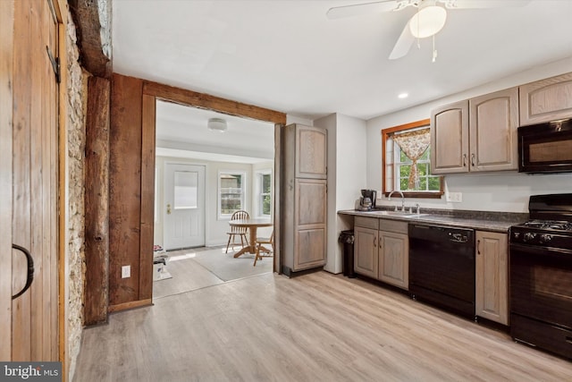 1127 Pawlings Rd, Norristown, PA 19403 - kitchen with black appliances, a sink, light wood-type flooring, dark countertops, and ceiling fan