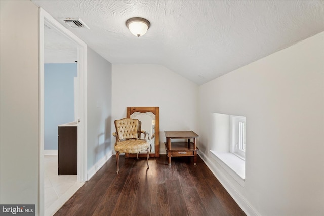 1127 Pawlings Rd, Norristown, PA 19403 - living area with vaulted ceiling, hardwood / wood-style floors, and a textured ceiling