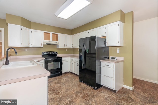 kitchen with black appliances, a sink, under cabinet range hood, light countertops, and white cabinets