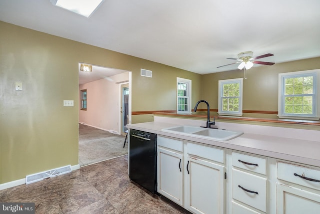 kitchen featuring dishwasher, a sink, white cabinetry, light countertops, and healthy amount of natural light