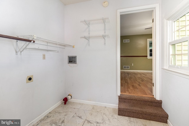 clothes washing area featuring hookup for an electric dryer, light marble finish floors, baseboards, and hookup for a washing machine