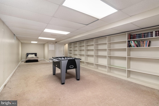 rec room with carpet floors, baseboards, built in features, and a paneled ceiling