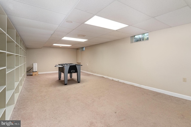 rec room with carpet flooring, a drop ceiling, and baseboards