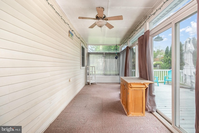 unfurnished sunroom with a ceiling fan and healthy amount of natural light