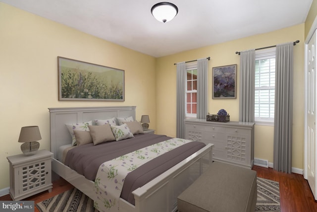 bedroom featuring baseboards and wood finished floors