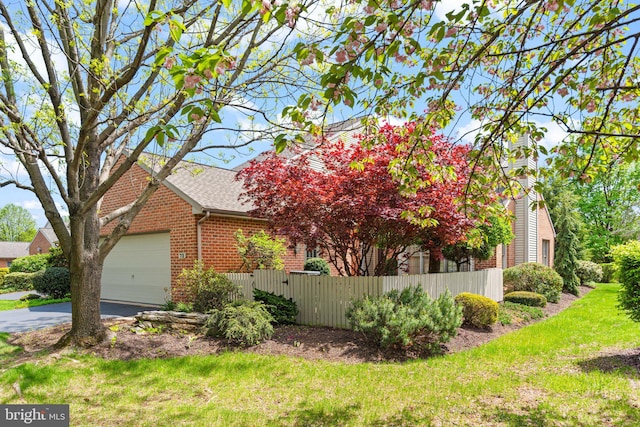 72 Leearden Rd, Hershey, PA 17033 - view of property exterior with brick siding, a garage, roof with shingles, and asphalt driveway