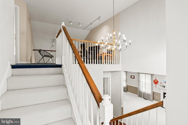 72 Leearden Rd, Hershey, PA 17033 - staircase with a high ceiling, a chandelier, track lighting, carpet floors, and a wainscoted wall