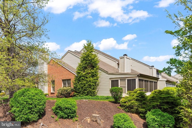 72 Leearden Rd, Hershey, PA 17033 - view of front of house featuring a chimney, a sunroom, and a shingled roof