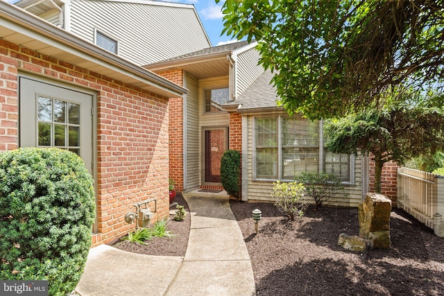 72 Leearden Rd, Hershey, PA 17033 - view of exterior entry with brick siding, roof with shingles, and fence