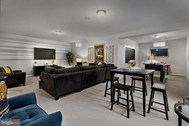 living room featuring baseboards and light carpet