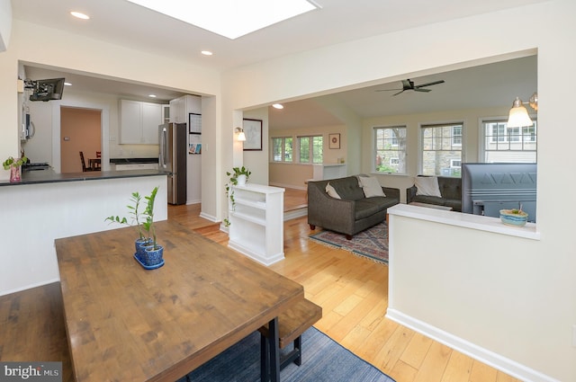 dining space with light wood-style flooring, a ceiling fan, and recessed lighting