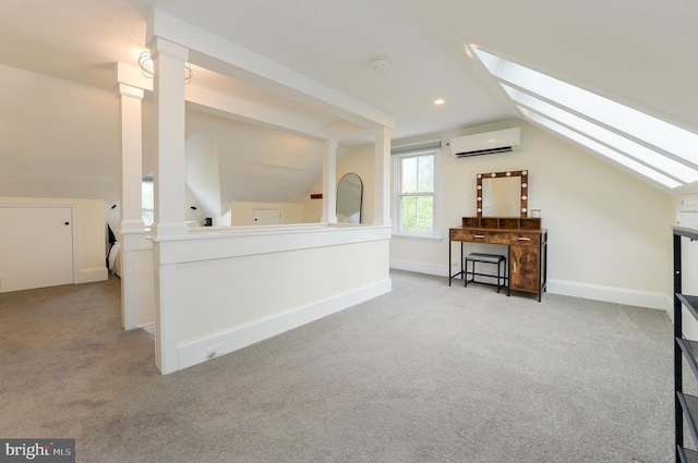 additional living space with an AC wall unit, a skylight, lofted ceiling, carpet flooring, and baseboards