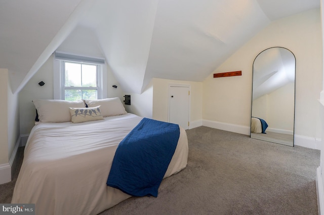 bedroom featuring lofted ceiling, carpet flooring, and baseboards