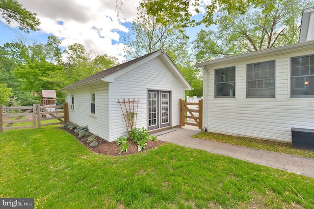 rear view of property featuring an outbuilding
