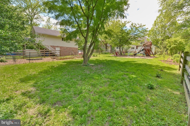 view of yard featuring stairway and a wooden deck