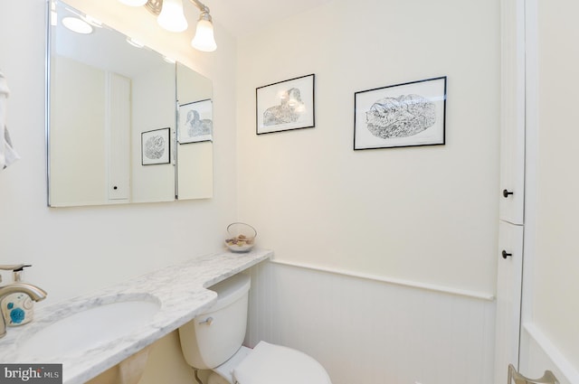 half bathroom featuring a sink and toilet