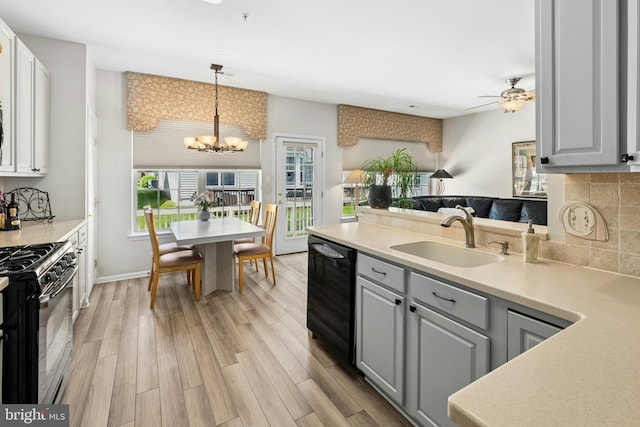 kitchen featuring a sink, black appliances, gray cabinets, a chandelier, and ceiling fan